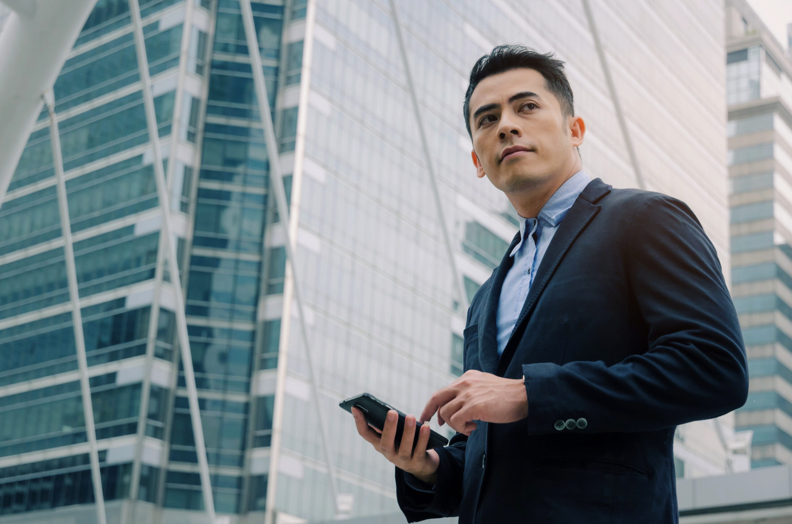 Young,Handsome,Asian,Business,Man,Wearing,Modern,Black,Suit,Reading shutterstock 1171235425 scaled