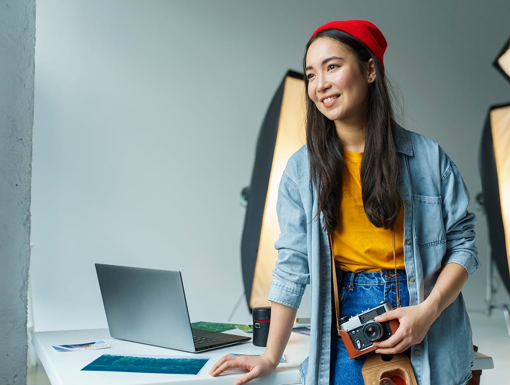 Smiling young woman working indoors at her office desk