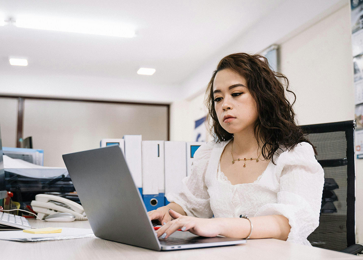 Offshore professional focused on work at their office workstation