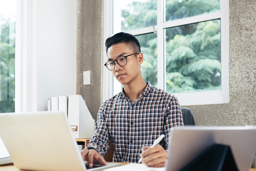 Offshore professional working on a laptop — Twoconnect staffing