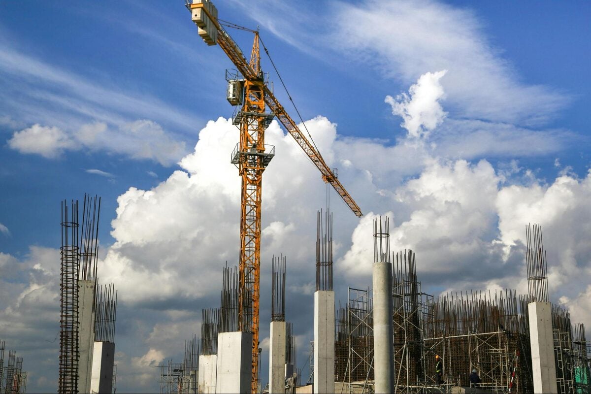 Tower crane above reinforced concrete columns on an active construction site