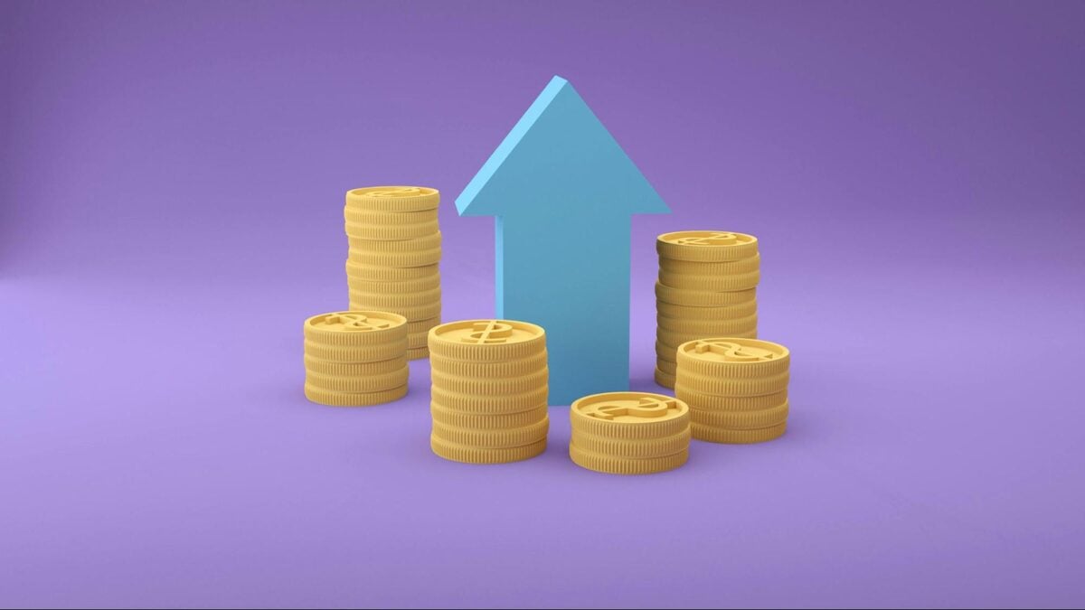 Stacks of gold coins with an upward arrow illustrating cost savings and growth