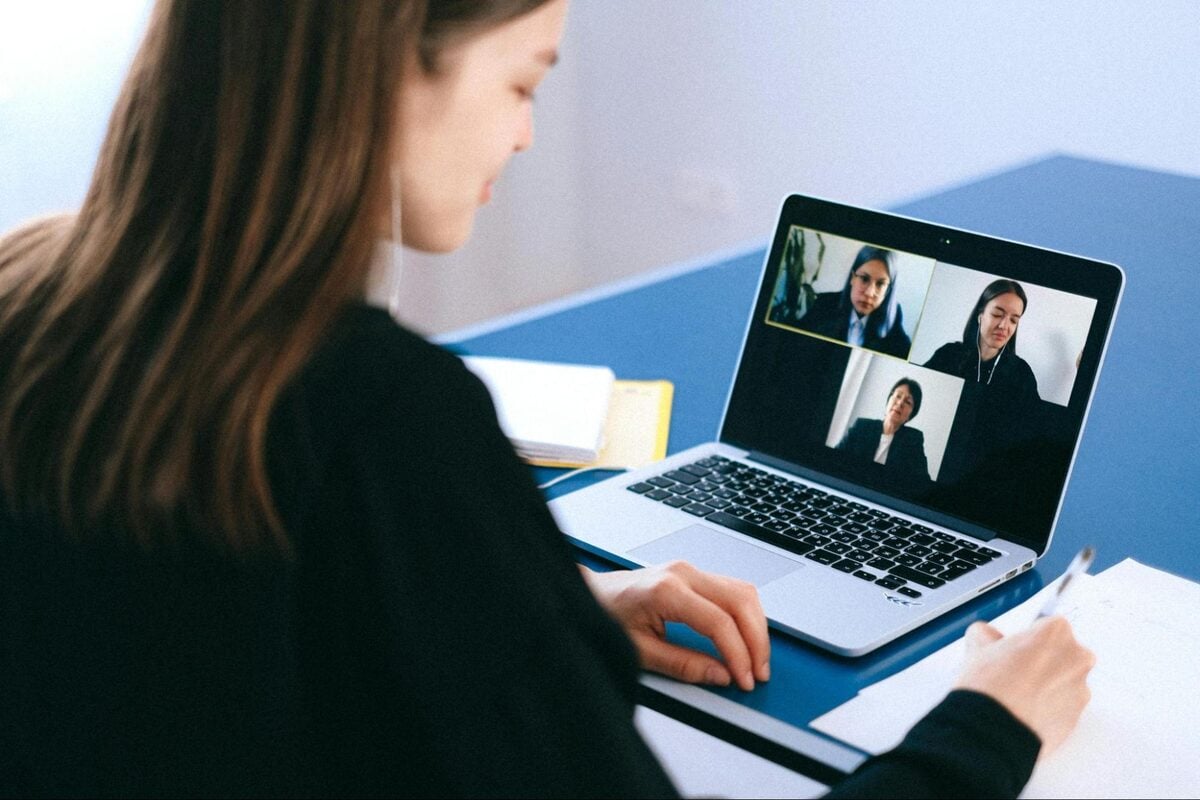 Woman on a laptop video call collaborating with a remote offshore team