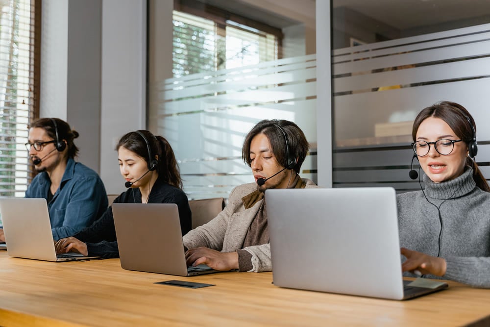 photo-of-coworkers-working-on-their-laptops